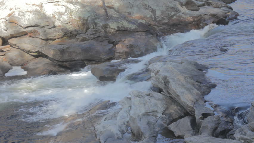 Kayakers navigating a Class IV+ rapid and flipping the kayak on the Chattooga River