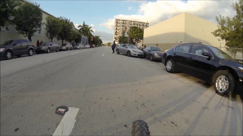 MIAMI, FL - NOVEMBER 23: POV  on bicycle, Man walking from his car after a collision on the side of the street on November 23, 2012 in Miami, FL.