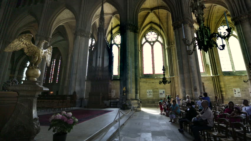REIMS, FRANCE - JULY 24, 2012: Tourists and believers in the wonderful Roman Catholic church where the kings of France were once crowned
