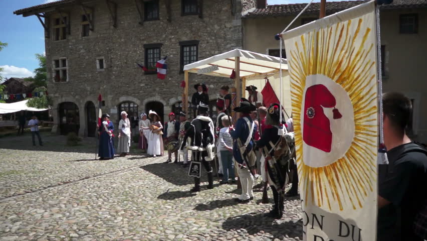 PEROUGES,FRANCE-JULY 14, 2012: French Revolution historic commemoration,with folks wearing common clothes of that time; patriots by the recruiters stand cry "Vive la Nation!" (Long live the Nation!)