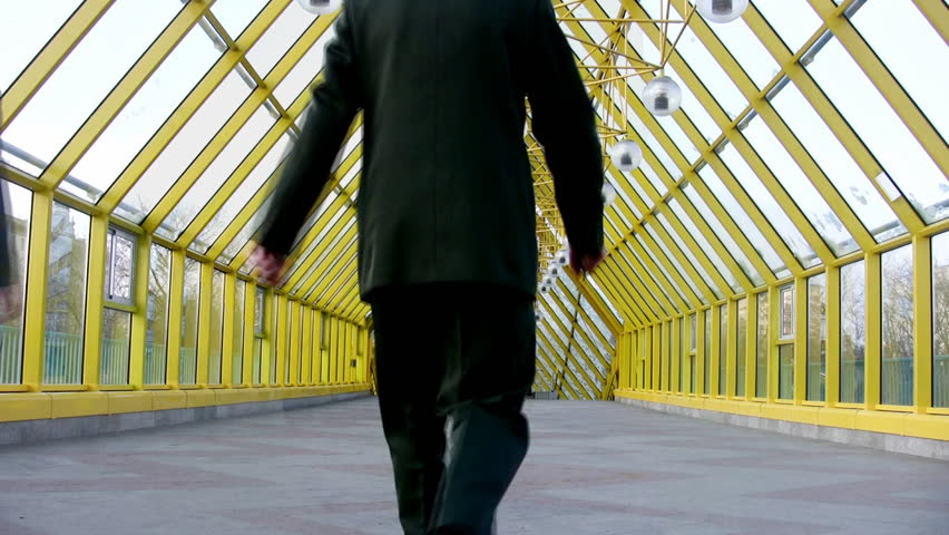 behind marching businessmen clones on bridge 