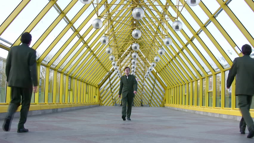 marching businessmen clones on bridge 