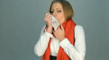 sick young woman in red scarf coughing and sneezing. video in studio