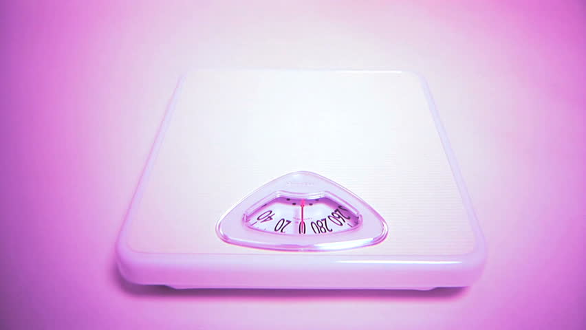 Composite of scale dial and man standing on scale