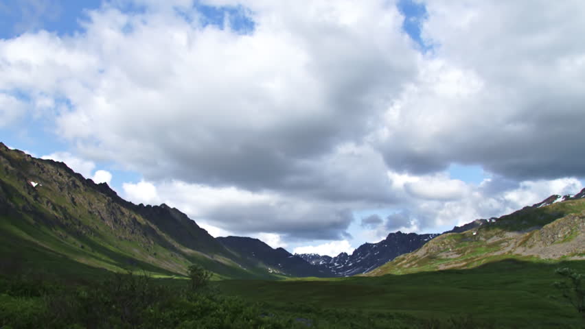 Mild timelapse clouds looking north up a valley in the Talkeetna range of Alaska near Hatcher Pass.