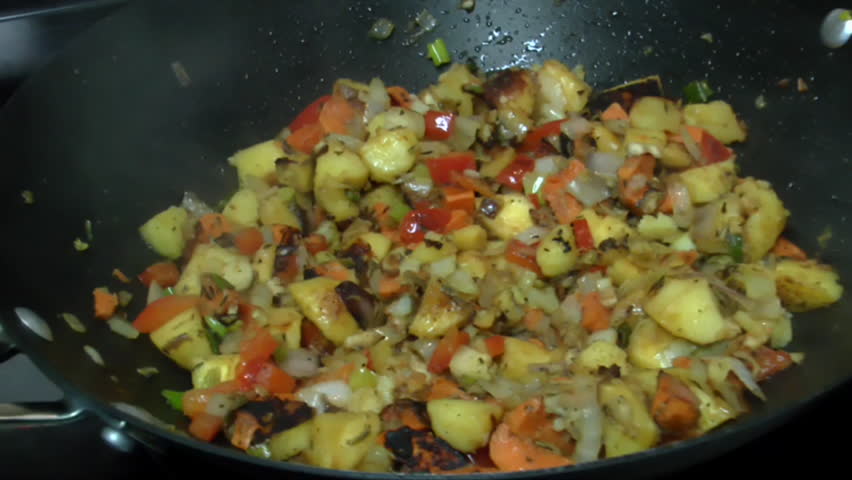 Chef POV, inhales enticing aroma of fresh, steaming organic vegetables sauteed in wok. 1080p