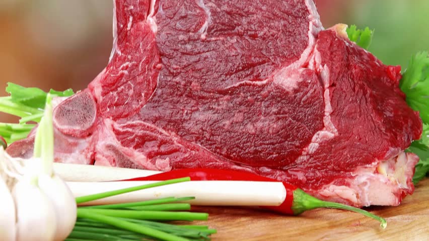 fresh meat : raw uncooked fat lamb pork rib with green stuff and red chili pepper on wooden plate isolated over white background