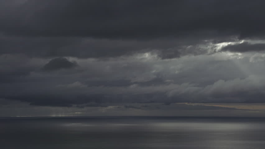 Light beams from the sun breaking though heavy shifting cloud cover over the Cook Inlet from the Homer Overlook.