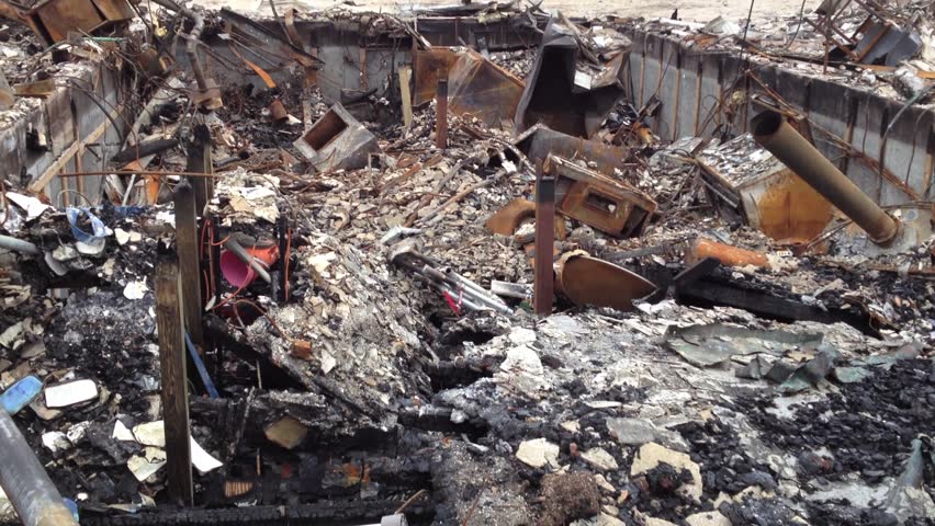 BREEZY POINT, QUEENS, NY-December 2, 2012: Video clip of wreckage and debris from homes destroyed by devastating fire during Hurricane Sandy. End of clip tilts up to reveal wreckage and reveals homes.
