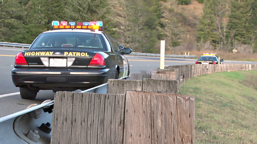 BLUE LAKE, CA - CIRCA 2012: Two California Highway Patrol cars with their lights on serve as warning to approaching motorists that an accident has made the road ahead dangerous.