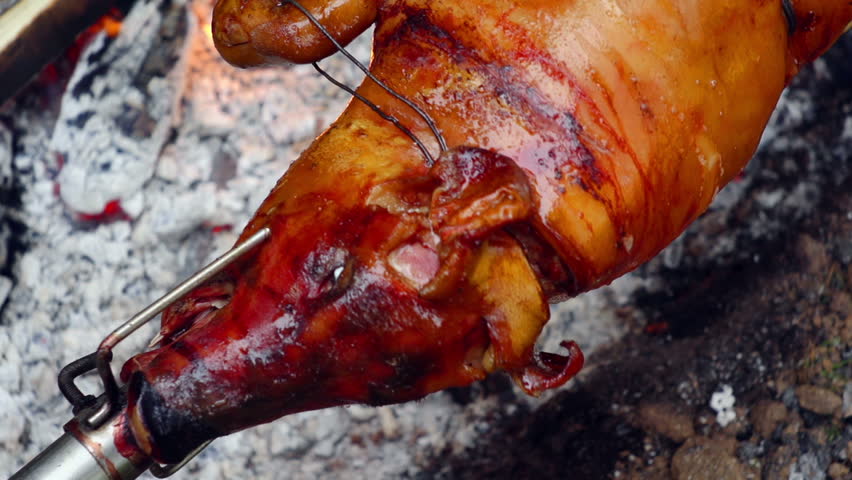 SUPER 35MM CAMERA - Pig on a spit turning slowly