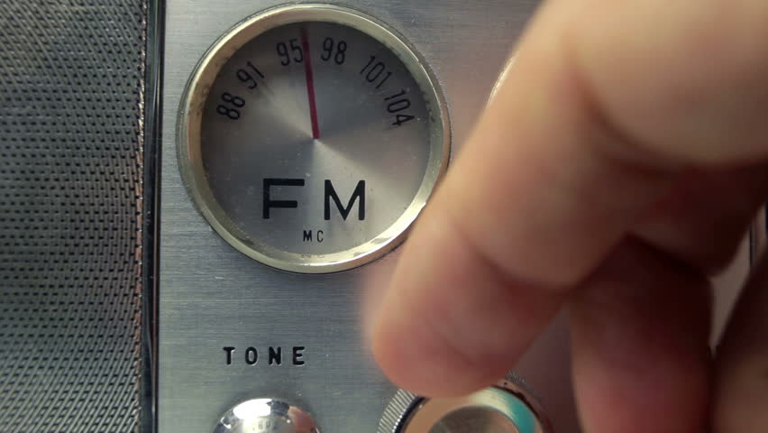 an old vintage portable FM and MW transistor radio with  the marker running through the different stations and frequencies