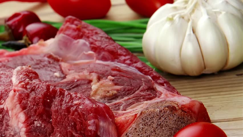 fresh meat : raw beef spare ribs with thyme red chili pepper garlic dill and cherry tomato on wooden board