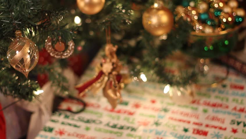 Smooth slider tracking shots of Christmas tree, gifts, and ornaments.