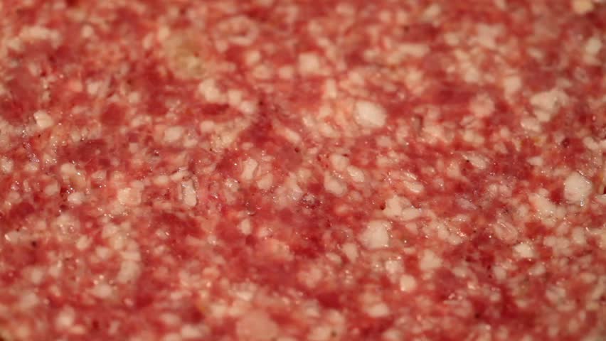 Sausage salami rotates closeup like appetizing background