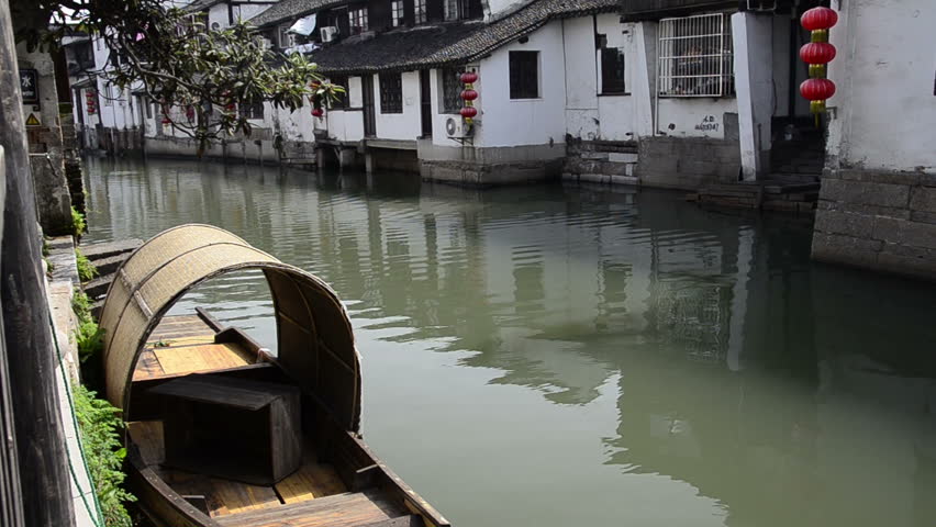 China, outskirts of Shanghai. Ancient water village of Zhujiajiao (aka Pearl Stream) with a long history dating back over 1,700 years to Qing Dynasty. Neighborhood river view with traditional boat.