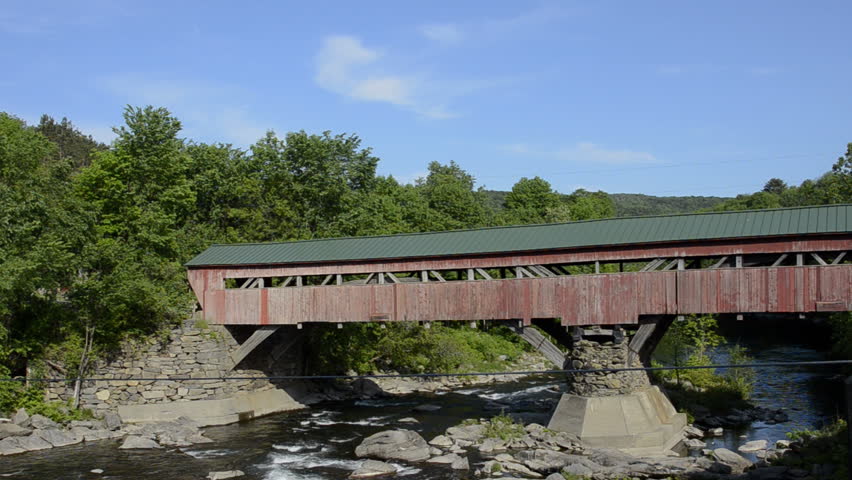 Old historic red old Covered Bridge over the river in Taftsville Vermont