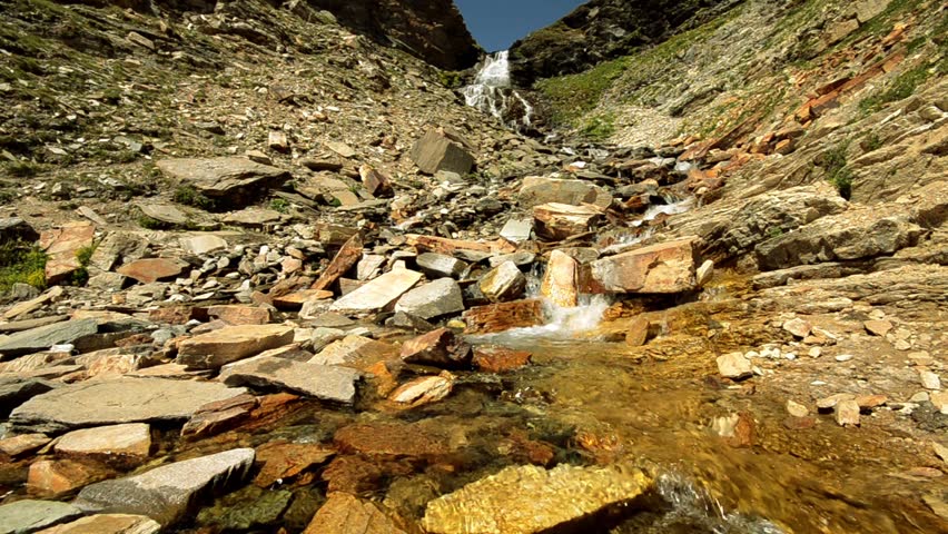 hiker crossing stream