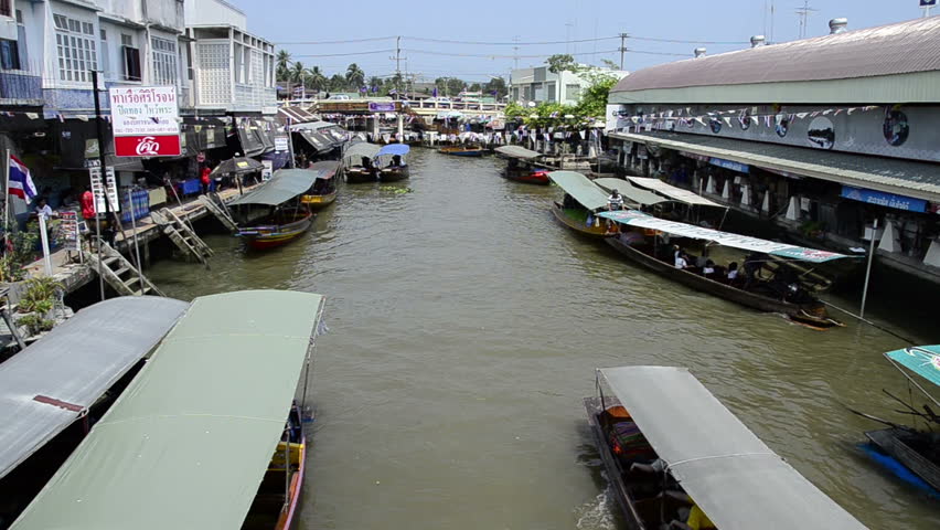 AMPHAWA, THAILAND - CIRCA Mar 2012: Amphawa Floating Market, popular waterfront market where vendors sell their goods from traditional longboats.