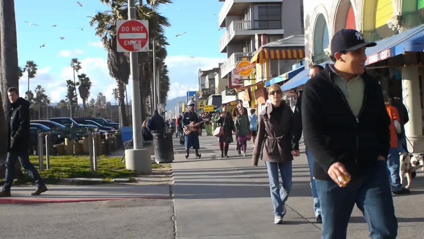 VENICE BEACH, CALIFORNIA - CIRCA 2011:  Tourists and locals walk on the boardwalk at Venice Beach, CA .
