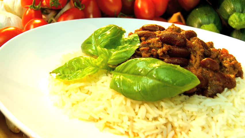 Healthy option meal of chilli beans & rice surrounded by the fresh vegetable ingredients