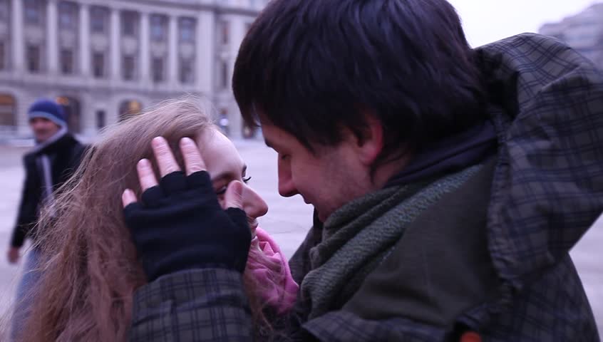 Young adult couple gets caught by paparazzi and runs from camera.
