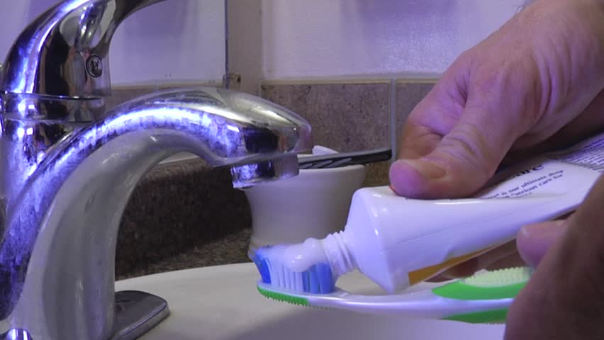 Attempting to brush teeth, but the water has been cut off.