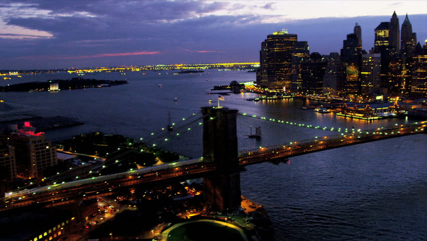 Aerial illuminated view Brooklyn Bridge, New York Harbor, Financial District, Downtown Manhattan, New York, USA