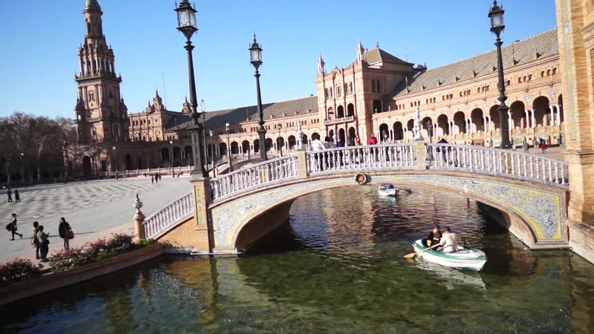 SEVILLE, SPAIN - JANUARY 6: Tourists enjoy a trip on boat on Plaza de Espana Seville on Jan 6, 2013 It was built in 1928 for the Ibero-American Exposition of 1929 designed by architect Anibal Gonzalez