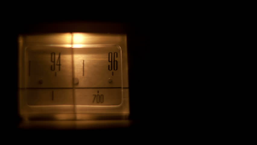 a glowing radio with the marker running through the different stations and frequencies