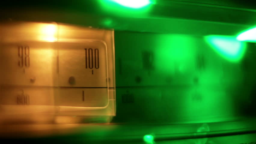 a glowing radio with the marker running through the different stations and frequencies