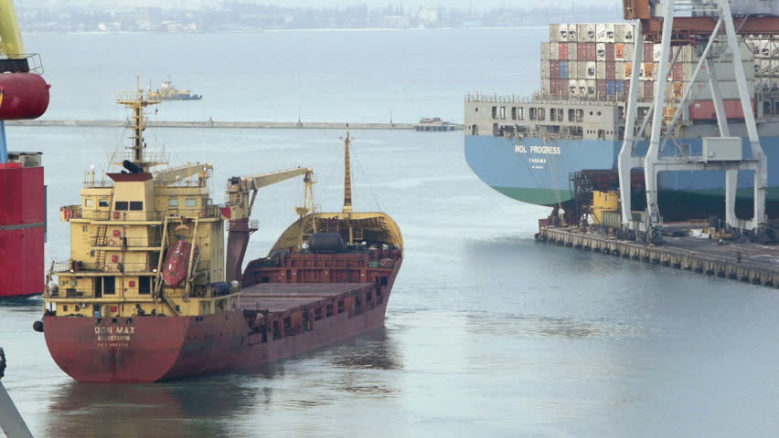 ODESSA - JANUARY 10: Cargo ship leaves port with tugs assistance on January 10, 2013 in Odessa, Ukraine. Odessa port is one of the largest trading ports located on the Black Sea coast.
