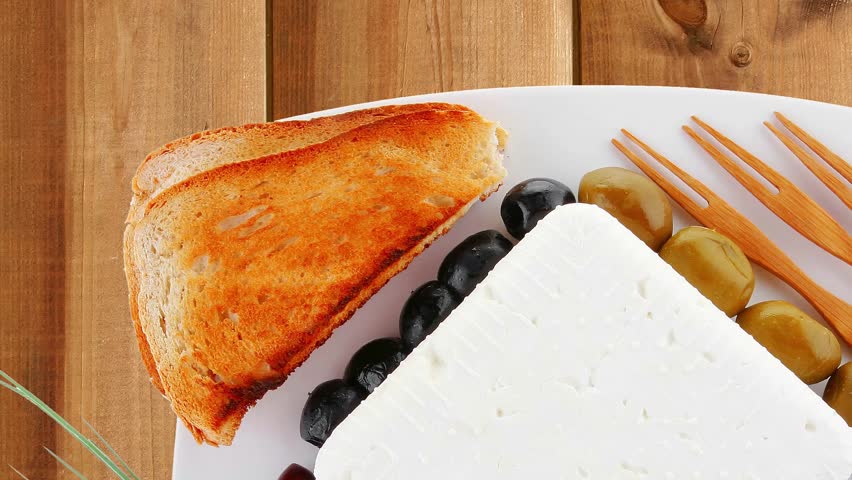 feta and olives with toast and tomatoes over wood hidef intro