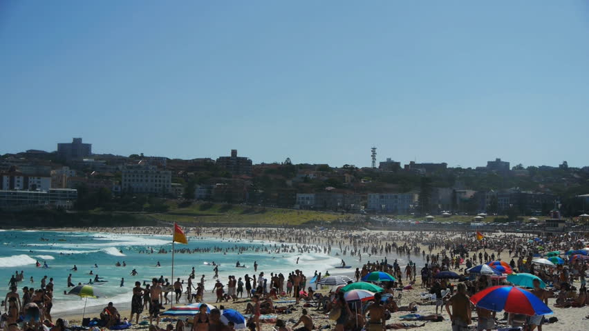 the view looking south on bondi beach on a busy summer day