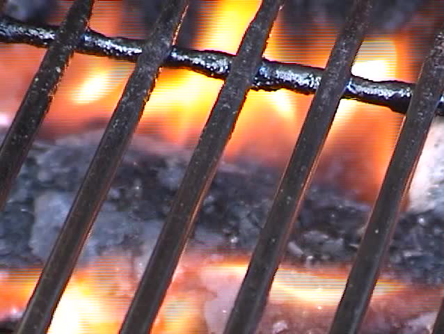 a bbq grill hot with fire from a gas flame