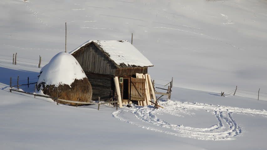 Wood house and haystack in a winter decor