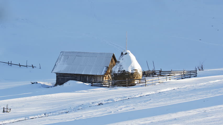 Small rural household covered with snow