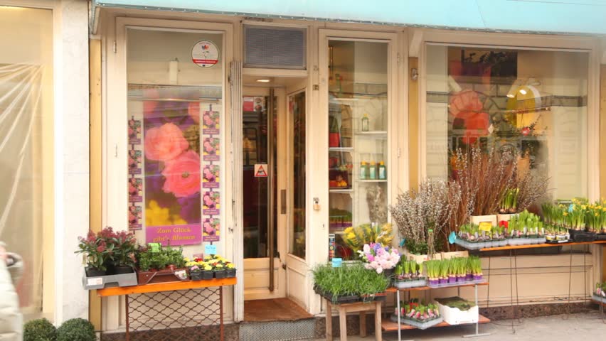 VIENNA- FEB 20: People pass by small flower shop on FEB 20, 2012 in Vienna, Austria. Vienna, the capital of Austria, is a paradise for all shopping addicts.