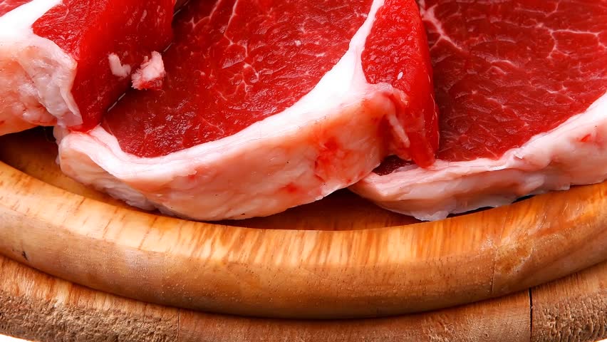 uncooked meat : raw fresh beef pork rib and fillet ready to cooking with garlic and green stuff over wood hidef slow motion intro