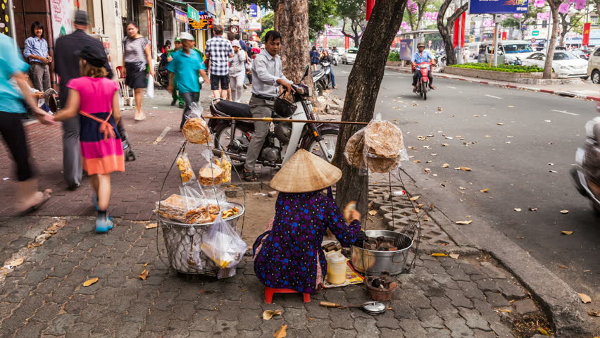 HO CHI MINH CITY, FEBRUARY 2: Timelapse view of a street vendor in the street of Ho Chi Minh City, Vietnam, on February 2, 2013