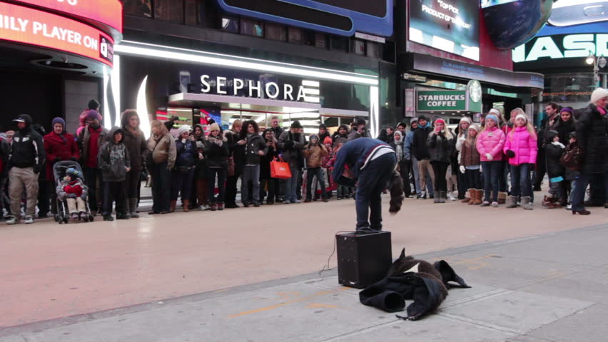 NEW YORK, NY - DECEMBER 23: Times square street performer with crowd during Christmas weekend on December 23, 2012 in New York, New York.