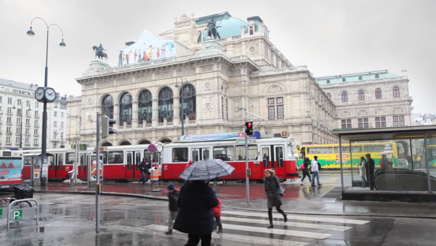 VIENNA- FEB 19: people cross street on transition about tram stop near Vienna State Opera, Feb 19, 2011, Vienna, Austria. Tram message appeared in Vienna in 1865, now totals about 179 km of tram ways.