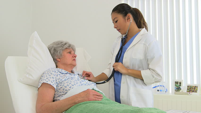 Female multiracial doctor performing a checkup on her patient