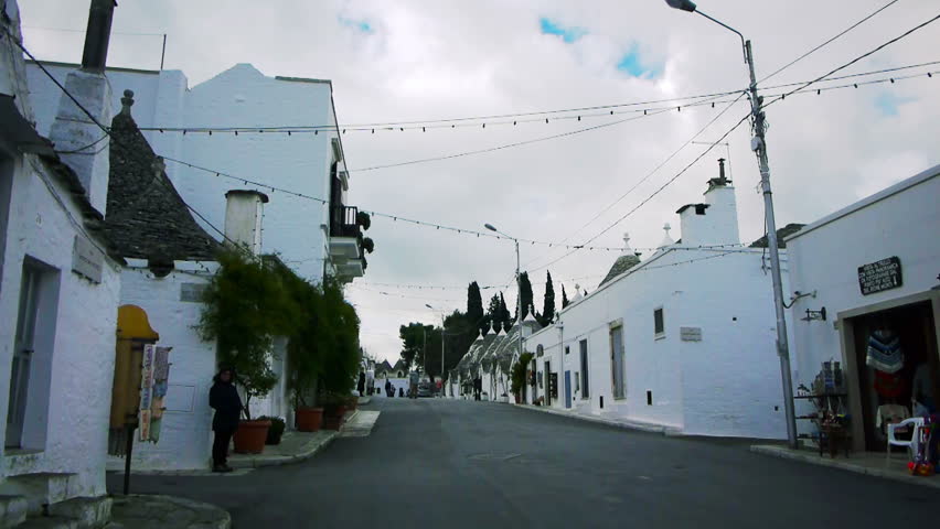 ALBEROBELLO, ITALY - DEC 18: Street leading to Saint Cosma and Damiano Basilica on December, 18, 2013, Alberobello, Italy. Alberobello is UNESCO World Heritage Site highly visited all year round