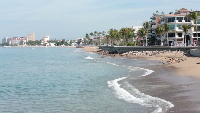 PUERTO VALLARTA, MEXICO NOV 2012: Economy and tourism bringing tourist back to Mexico. Puerto Vallarta city boadwalk bay beach pan. Cultural and artistic center of the city.