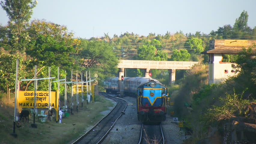 MAKALIDURGA, KARNATAKA, INDIA - JAN 01, 2008.  Diesel locomotive engine passing through Makalidurga station with evening passenger train near Bangalore India.