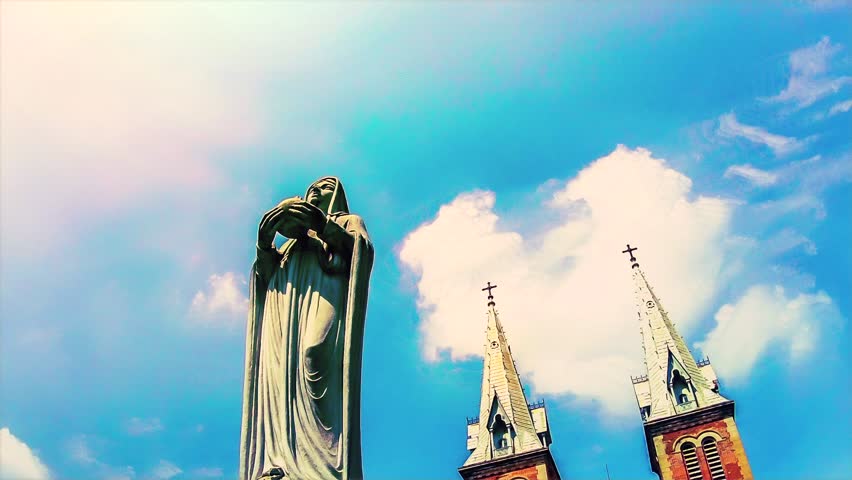 HO CHI MINH CITY - CIRCA 2012: Time lapse of a statue in front of a church in Ho Chi Minh City (formerly Saigon), Vietnam circa 2012.