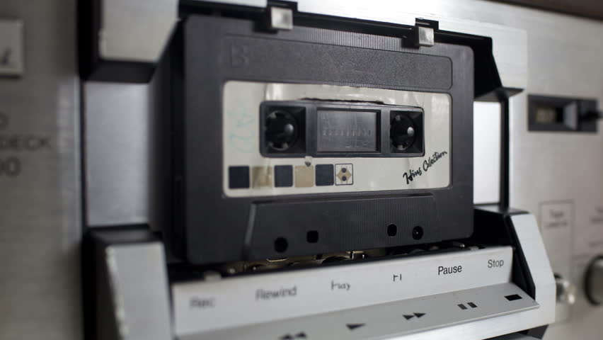 sequence of old audio cassettes in a retro tape player

