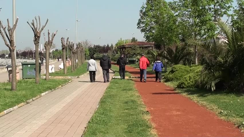 sportive people are walking along the seashore 