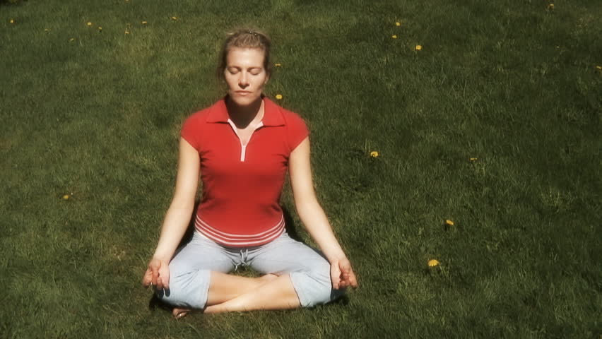 woman practicing relaxation and breathing exercise in an outdoor surrounding